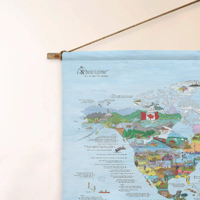 Top left corner of the Bucketlist Map roll down canvas of the world hanging on a wall.