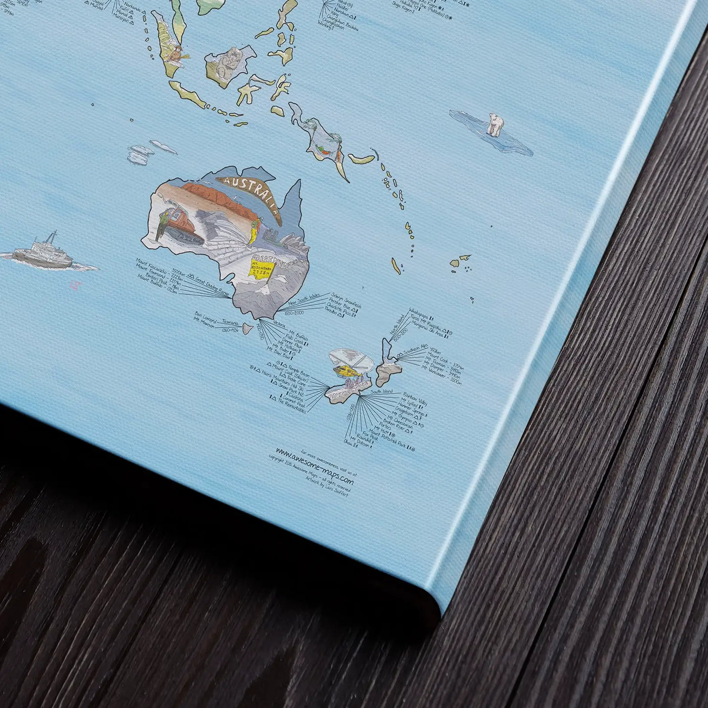 Bottom right corner of the Snowtrip Map canvas of the world lying flat on a table