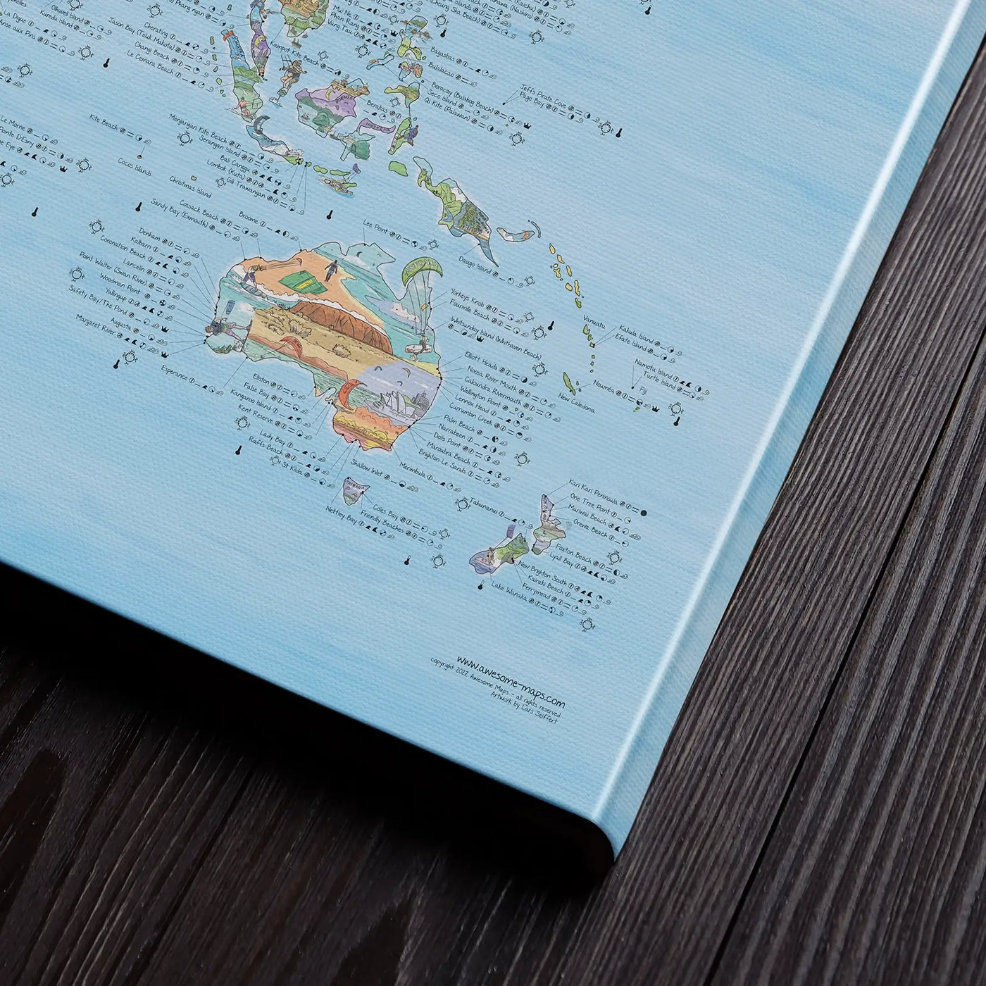 Bottom right corner of the Kitesurf Map canvas of the world lying flat on a table