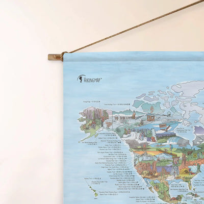 Top left corner of the Hiking Map roll down canvas of the world hanging on a wall