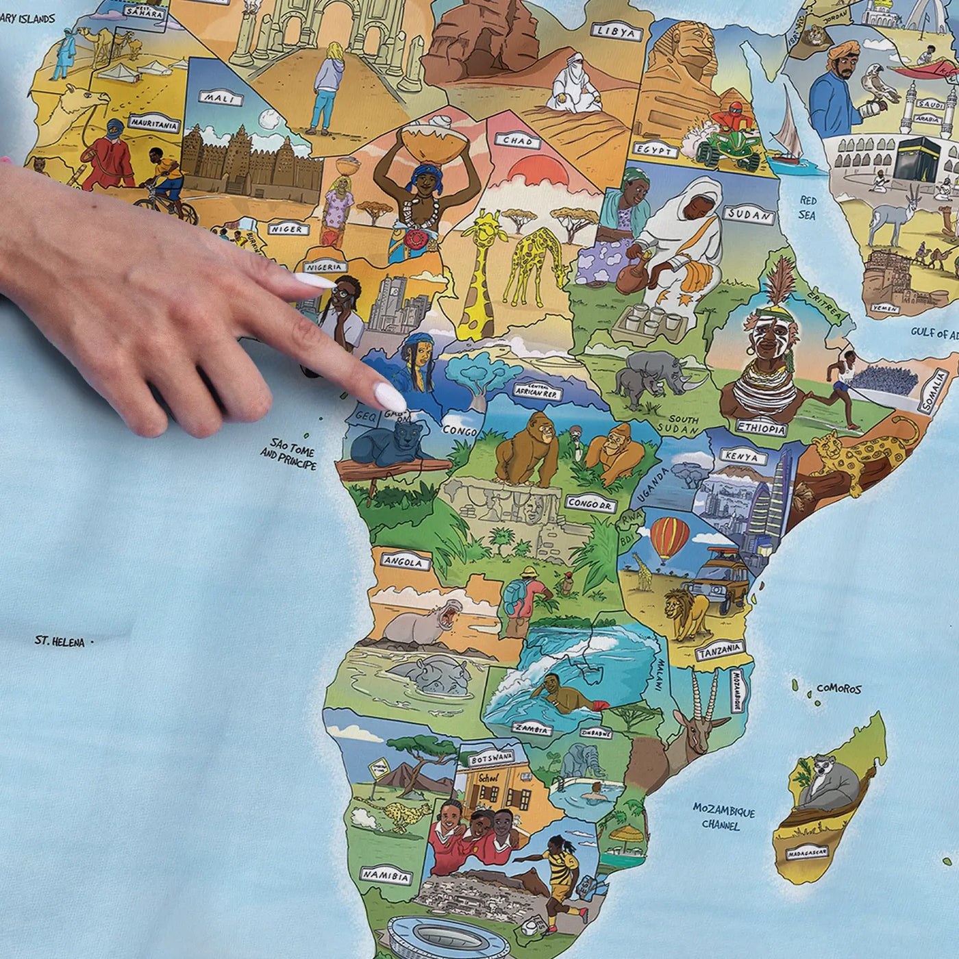 Close-up of the Little Explorers Map towel highlighting icons on traditional dress and food from around the world