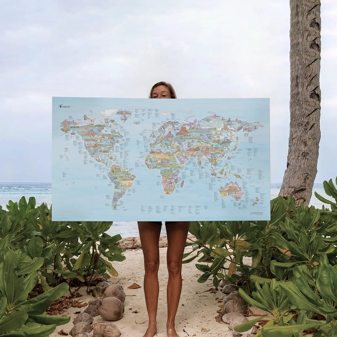 Someone holding the Fishing Map canvas at the beach