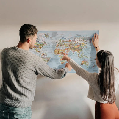 A couple looking at the Hiking Map poster hanging on the wall