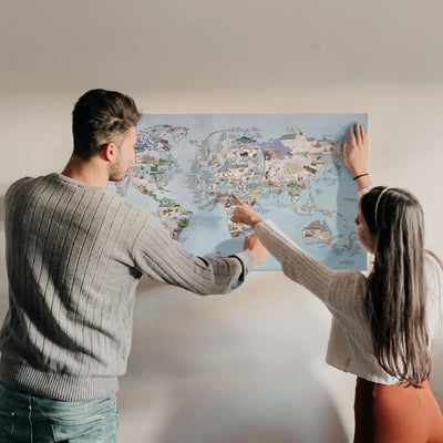 A couple looking at the Snowtrip Map poster hanging on the wall