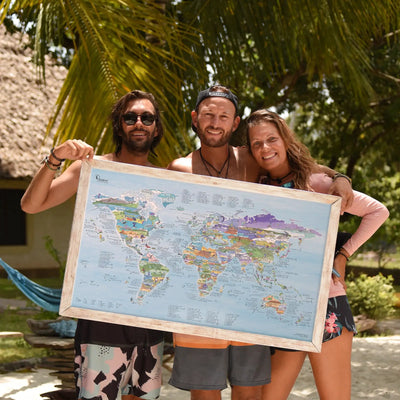 People holding up a framed version of the Kitesurf Map poster