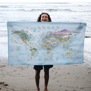 Someone holding the Kitesurf Map towel at the beach